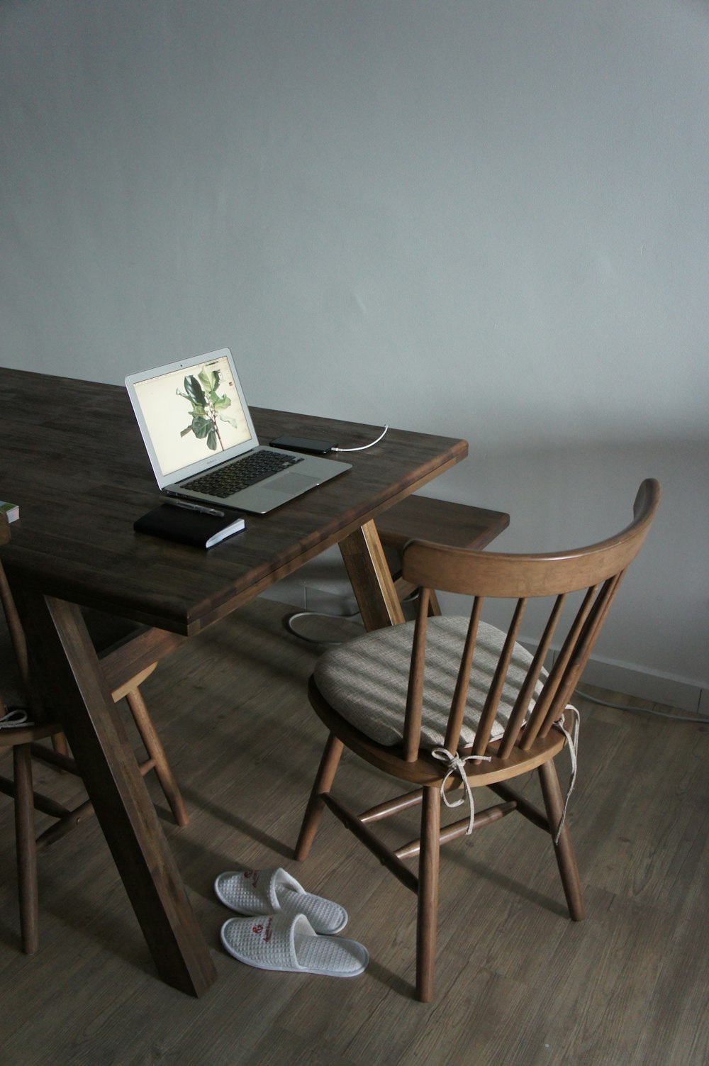 black laptop computer on brown wooden table