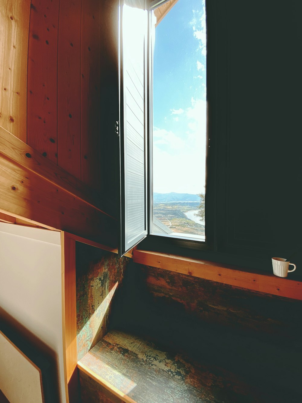 brown wooden cabinet beside window
