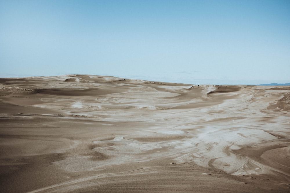 white sand under blue sky during daytime