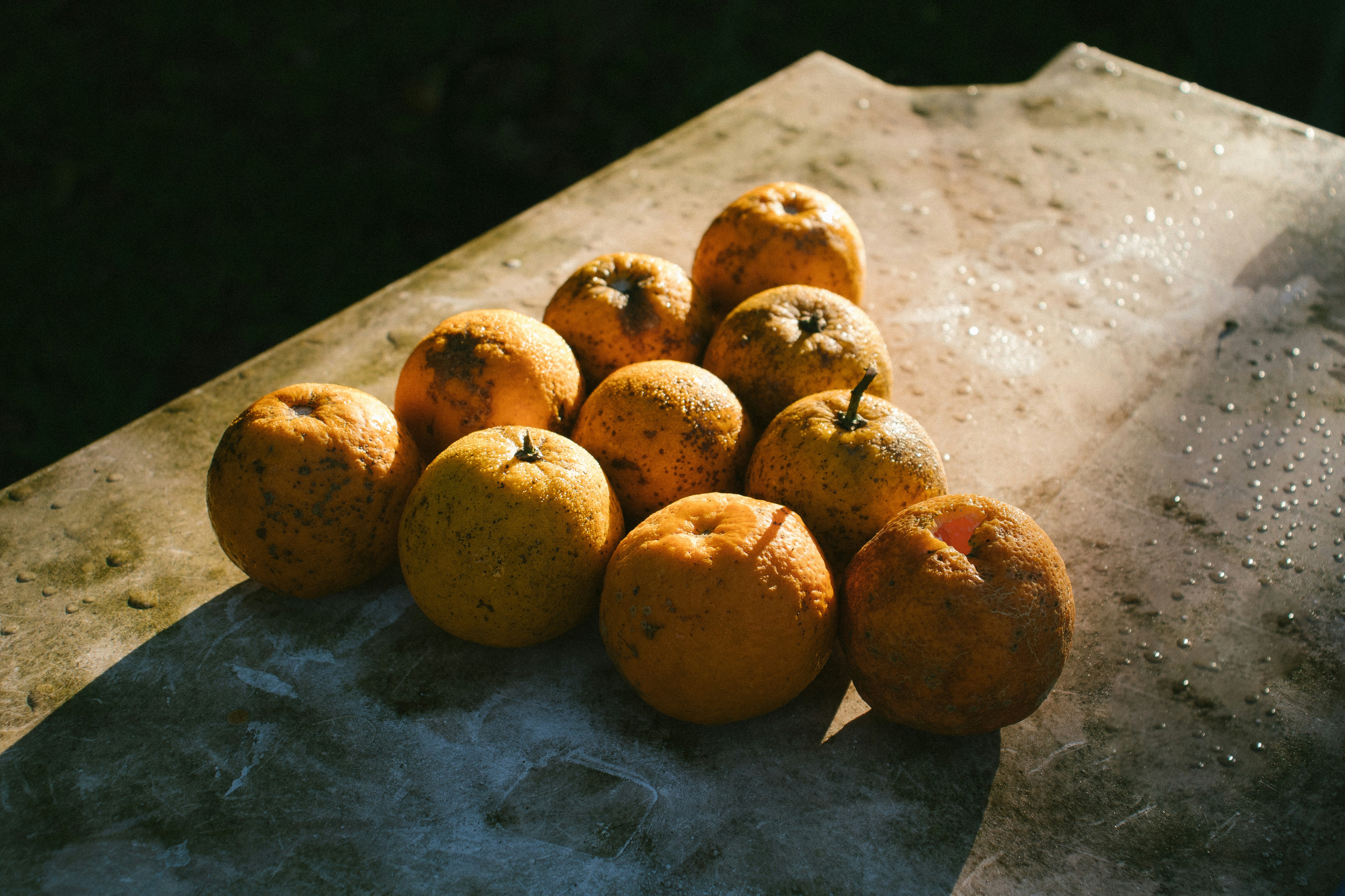 yellow round fruits on gray table