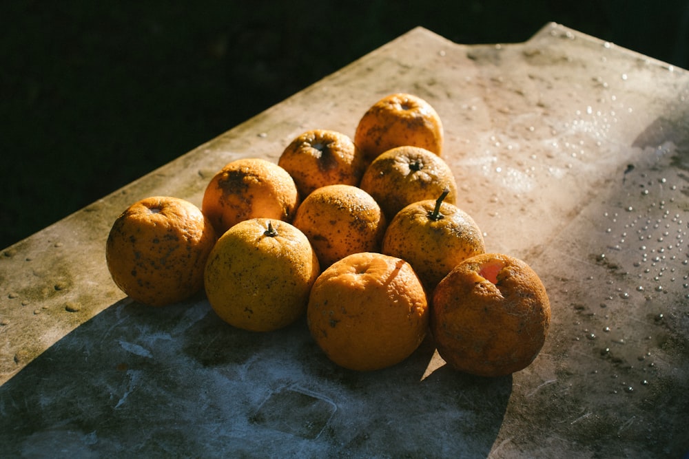 yellow round fruits on gray table