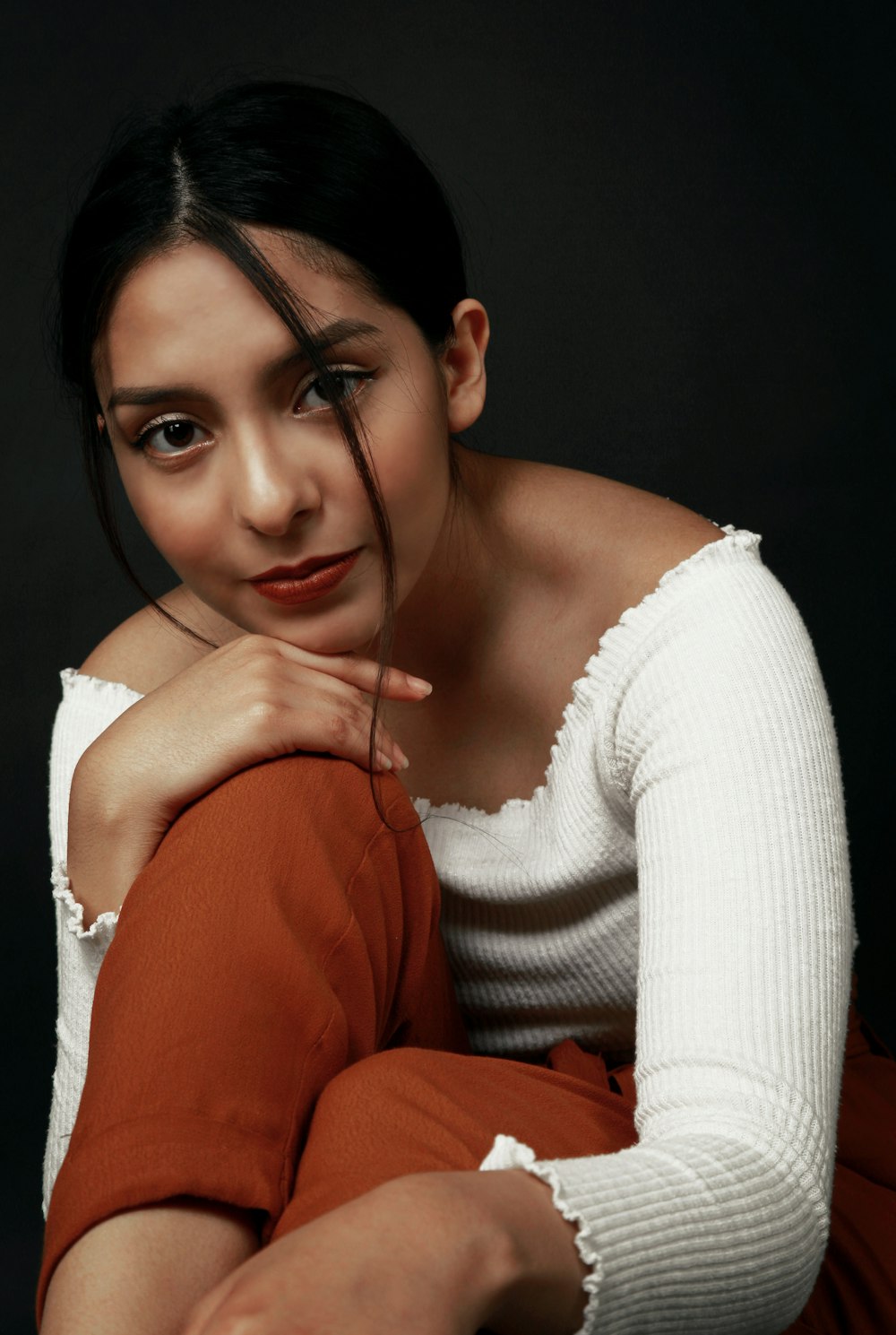 woman in white knit sweater wearing black framed eyeglasses