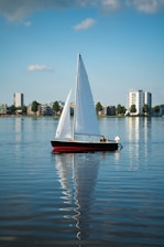 red and white boat on sea during daytime