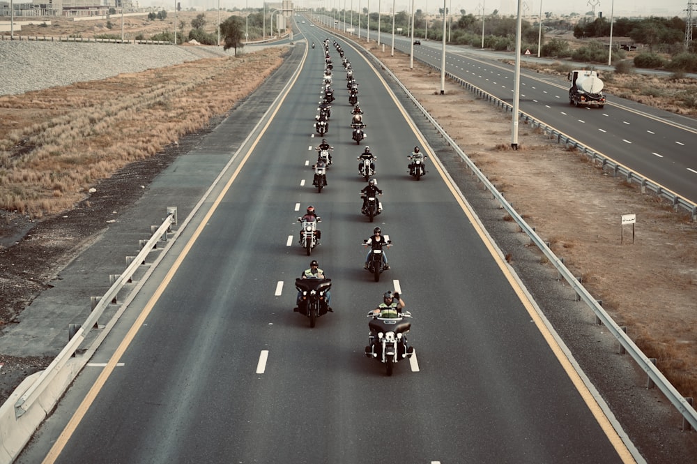 people riding motorcycle on road during daytime