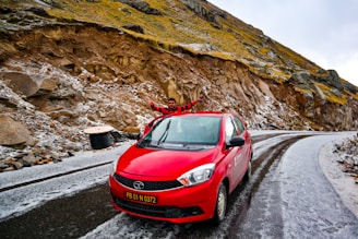 An influencer showcasing a new car model on a scenic mountain road, capturing breathtaking shots.