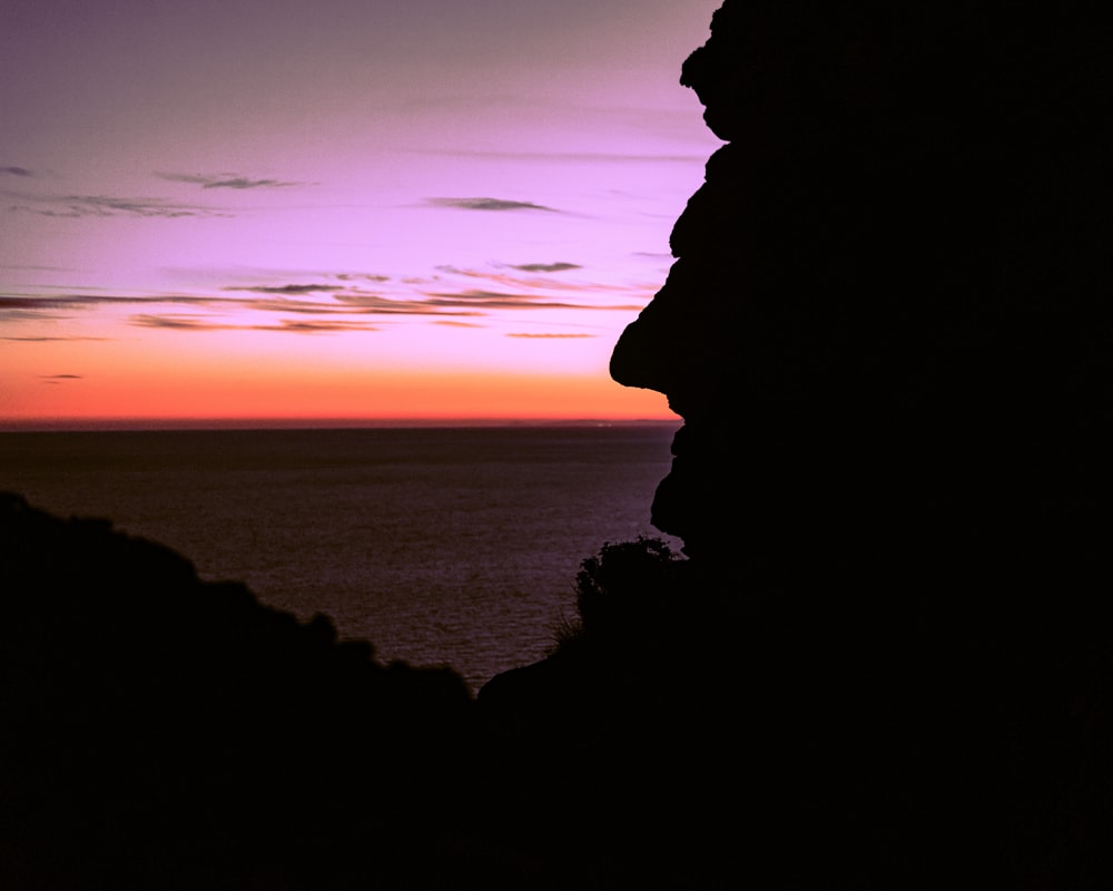 silhouette of rock formation during sunset