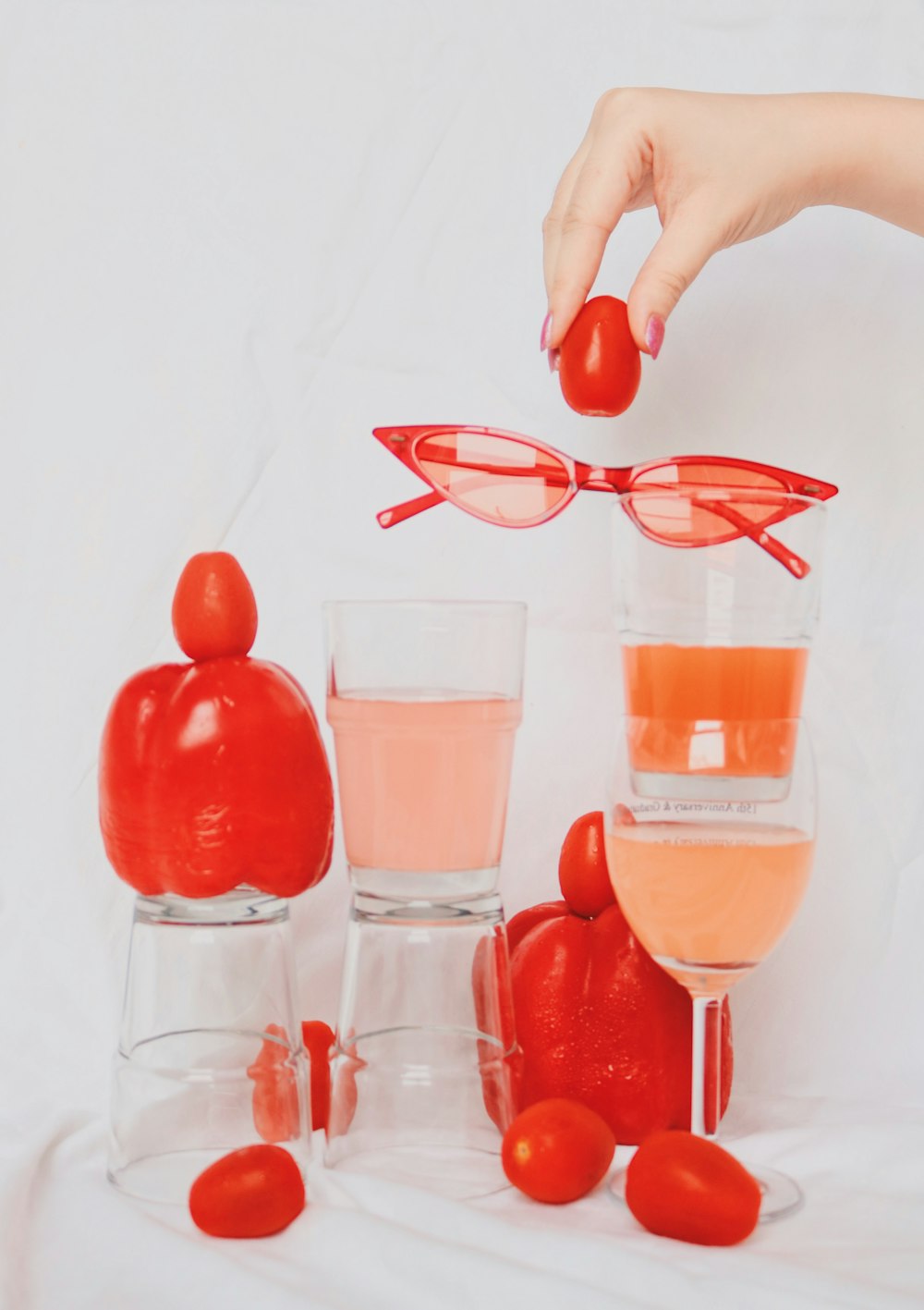 2 clear drinking glasses with red liquid