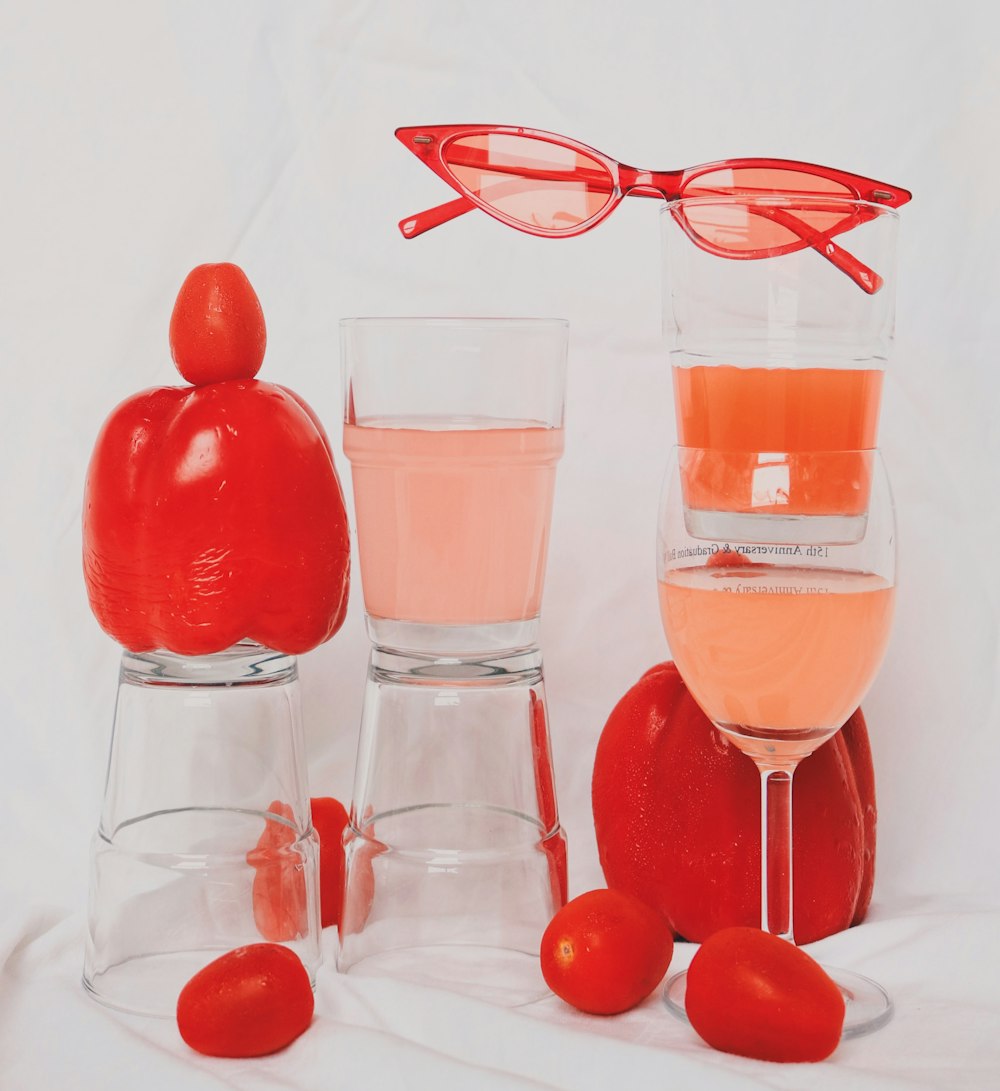 two clear wine glasses with pink liquid