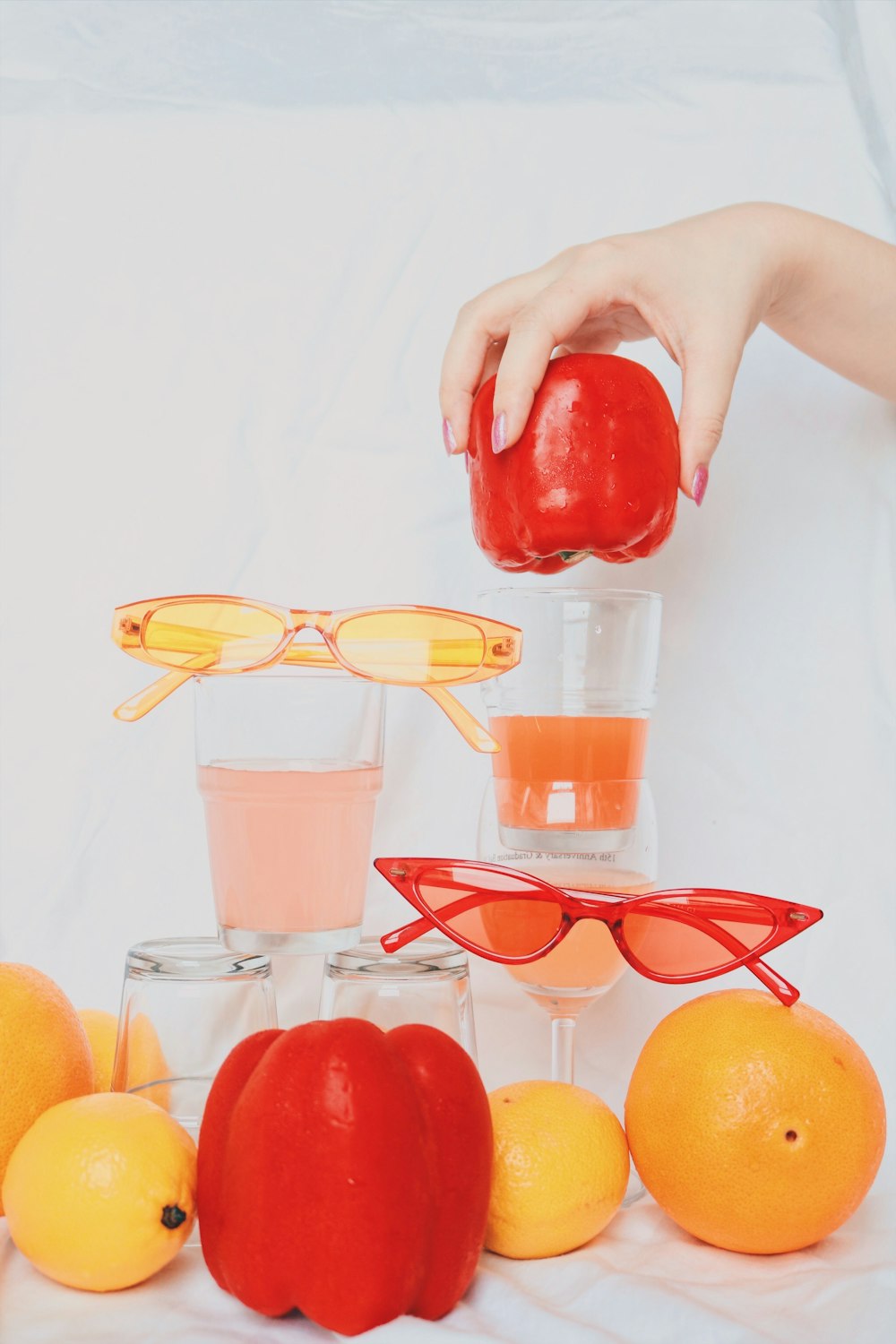 person holding red and yellow framed eyeglasses