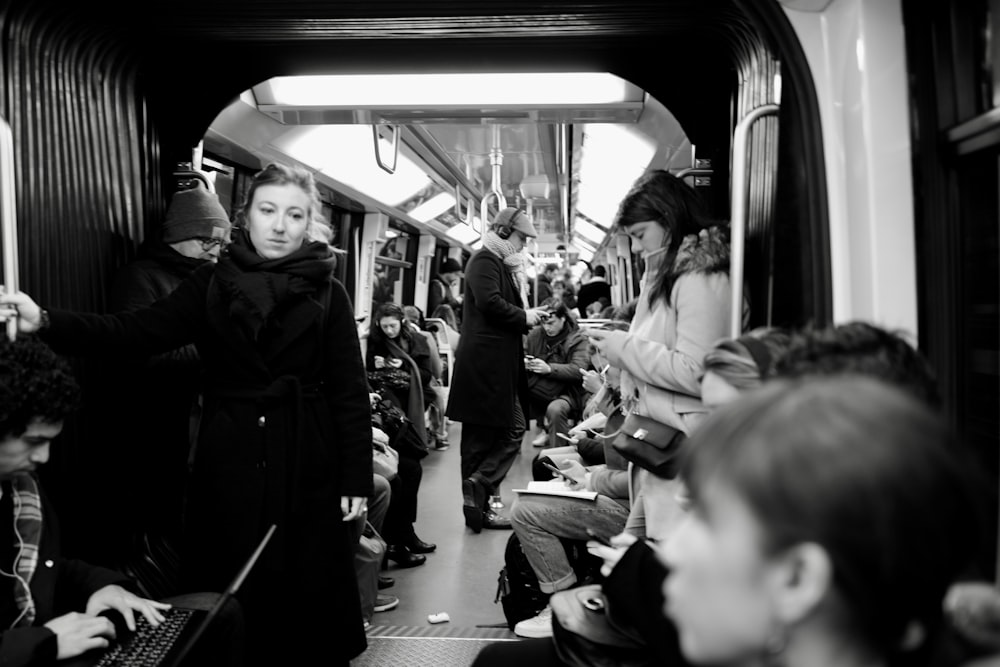 grayscale photo of people in train