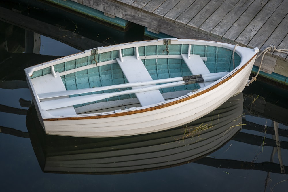 white and blue boat on water