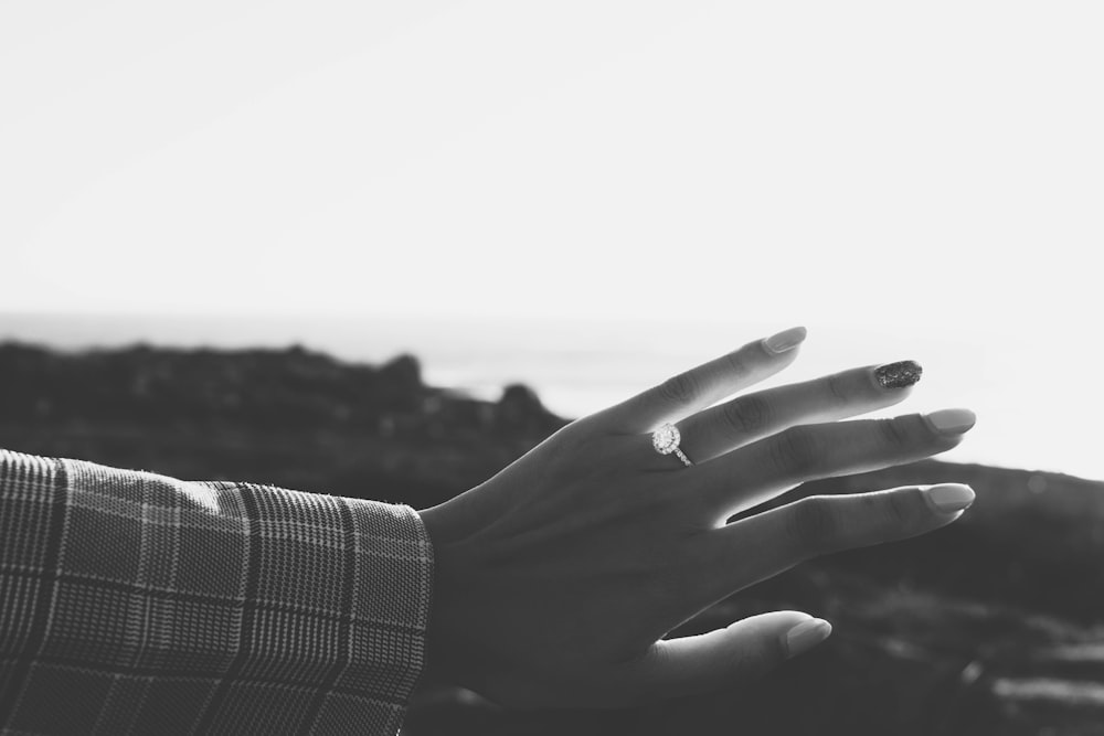 grayscale photo of persons hand