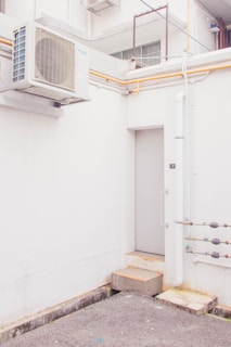 white wooden door near white wall