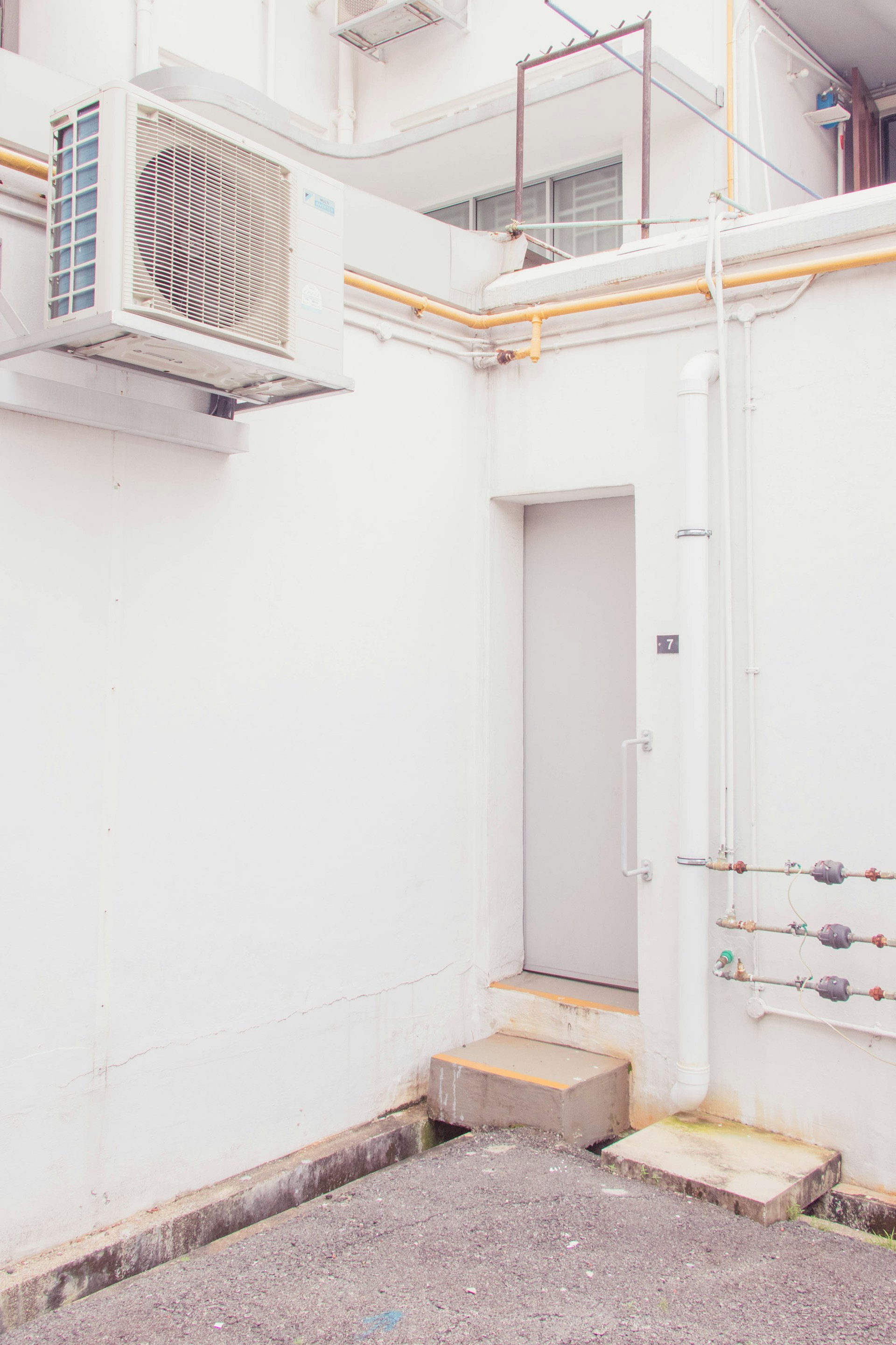 white wooden door near white wall