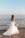 woman in white wedding dress standing on beach during daytime