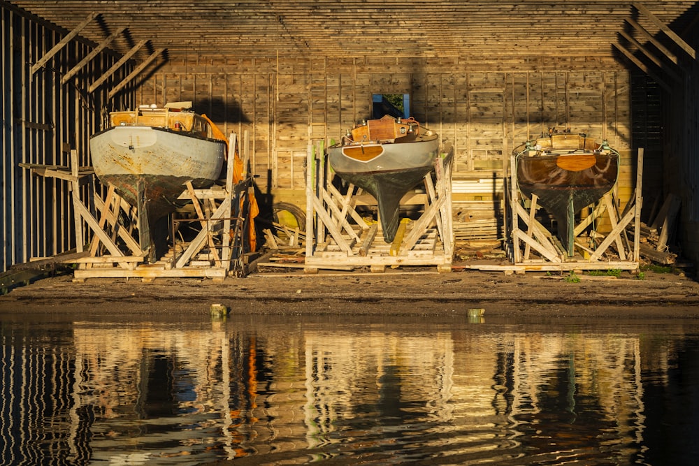 people sitting on white wooden chair near body of water during daytime