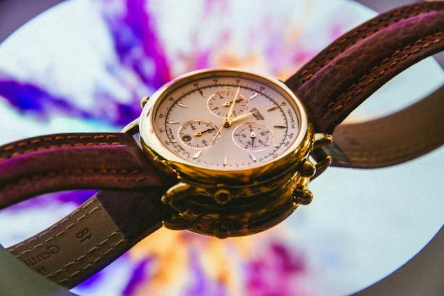 gold and white round chronograph watch