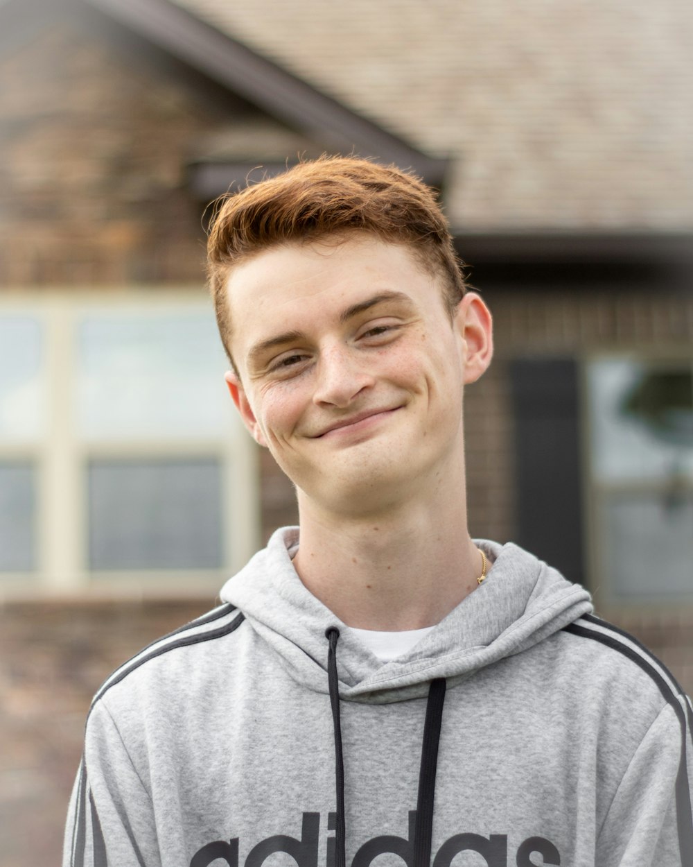 man in gray hoodie smiling