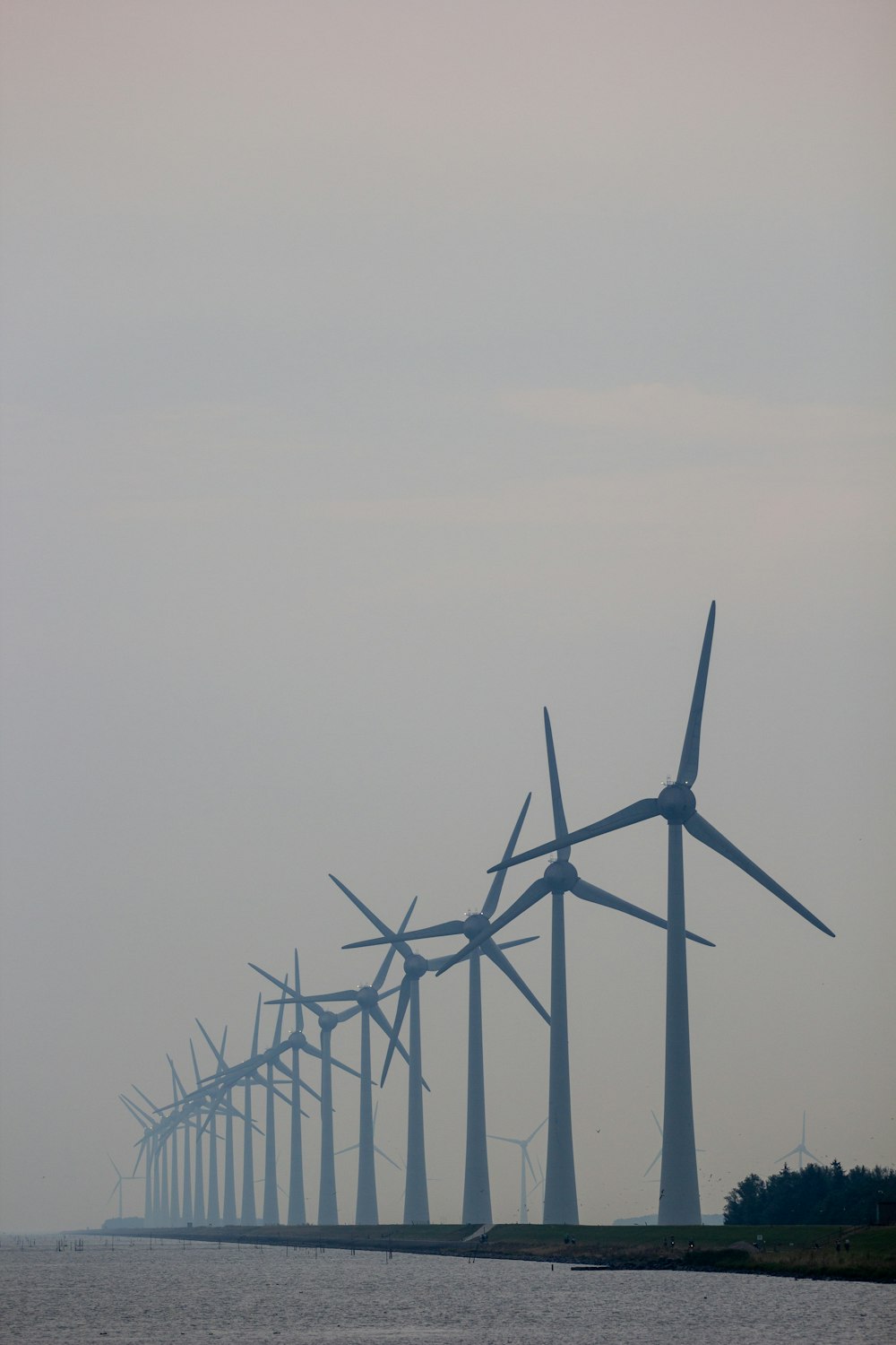 wind turbines under gray sky