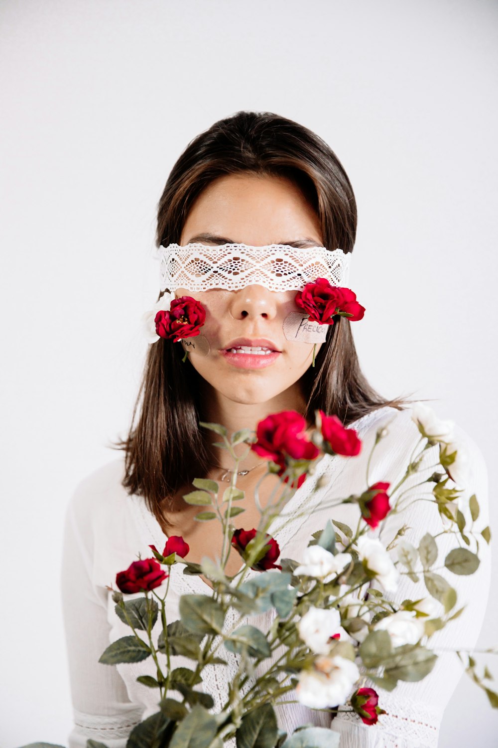 woman in white shirt with red and white flower headband