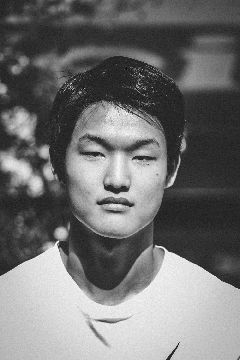 grayscale photo of man in white crew neck shirt