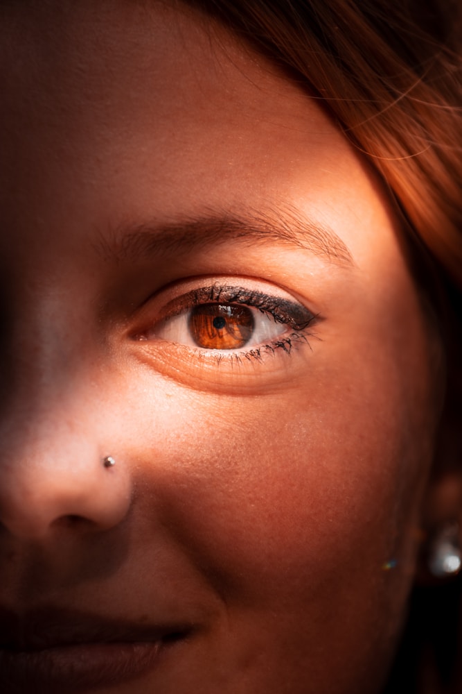 Detail of a gold nose hoop on a healed piercing