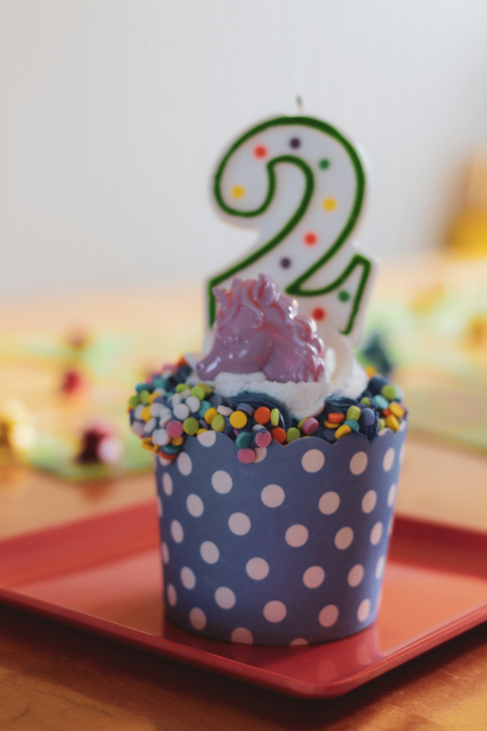 white and black polka dot cupcake with white icing on top