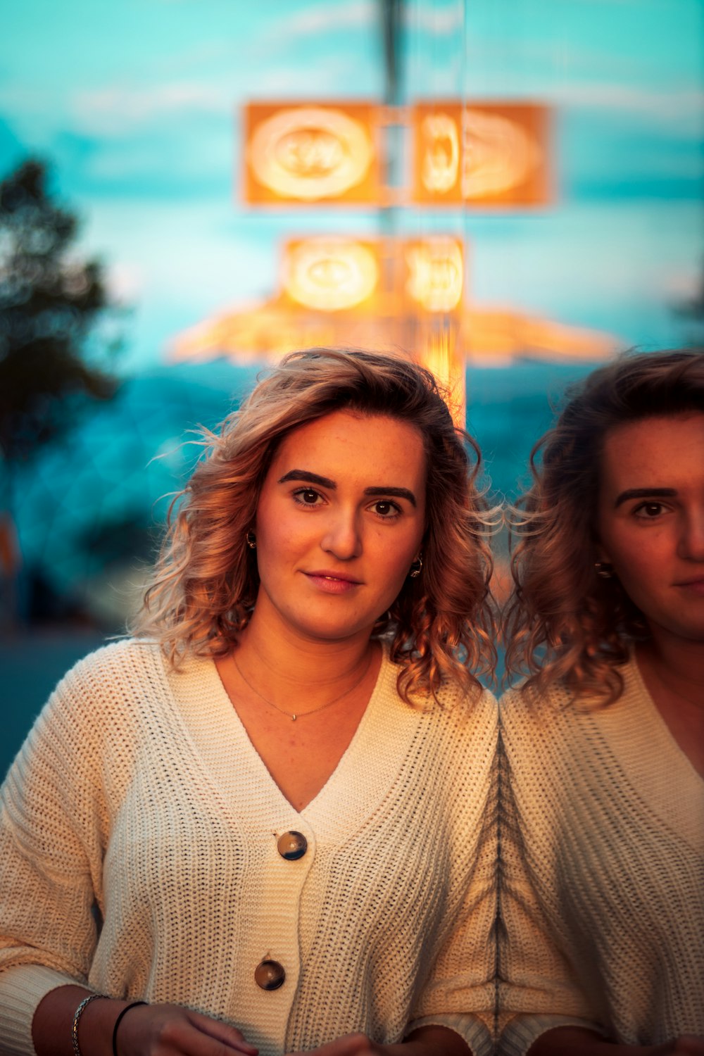 2 women in white knit shirt