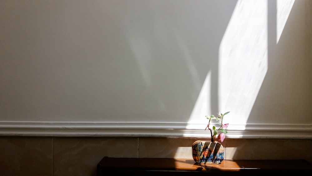 white ceramic vase on brown wooden table