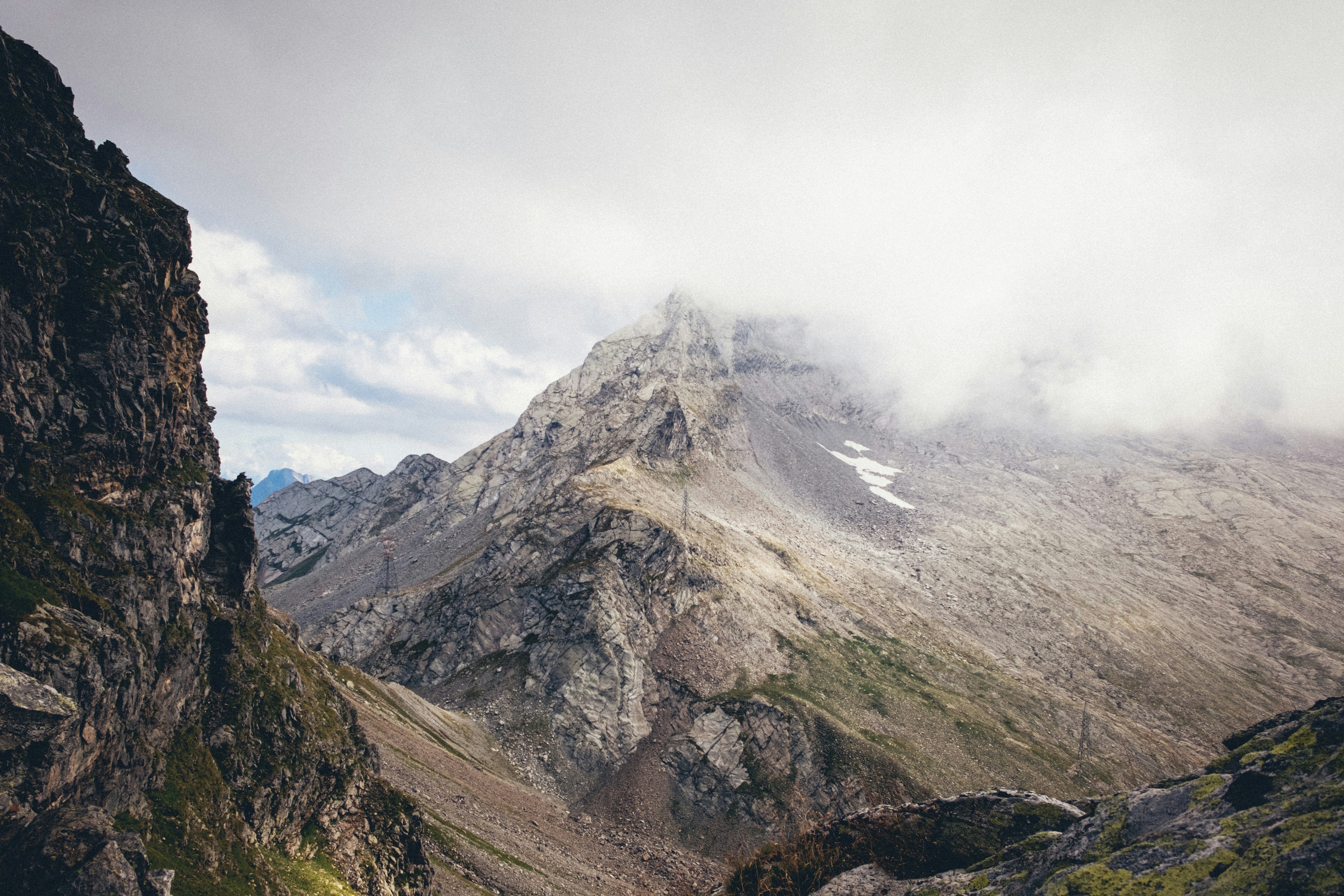 gray and white mountain under white clouds during daytime