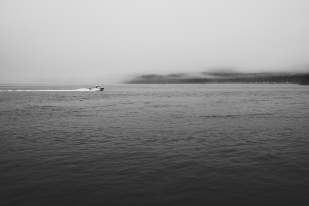 grayscale photo of boat on sea