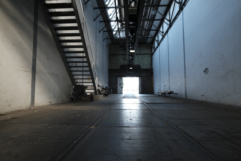 gray concrete hallway with white wall