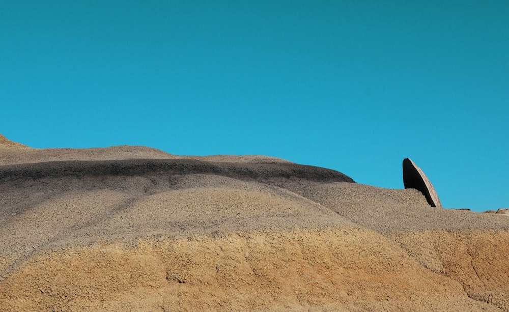 brown sand under blue sky during daytime