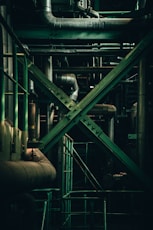 green metal pipe near gray metal pipe