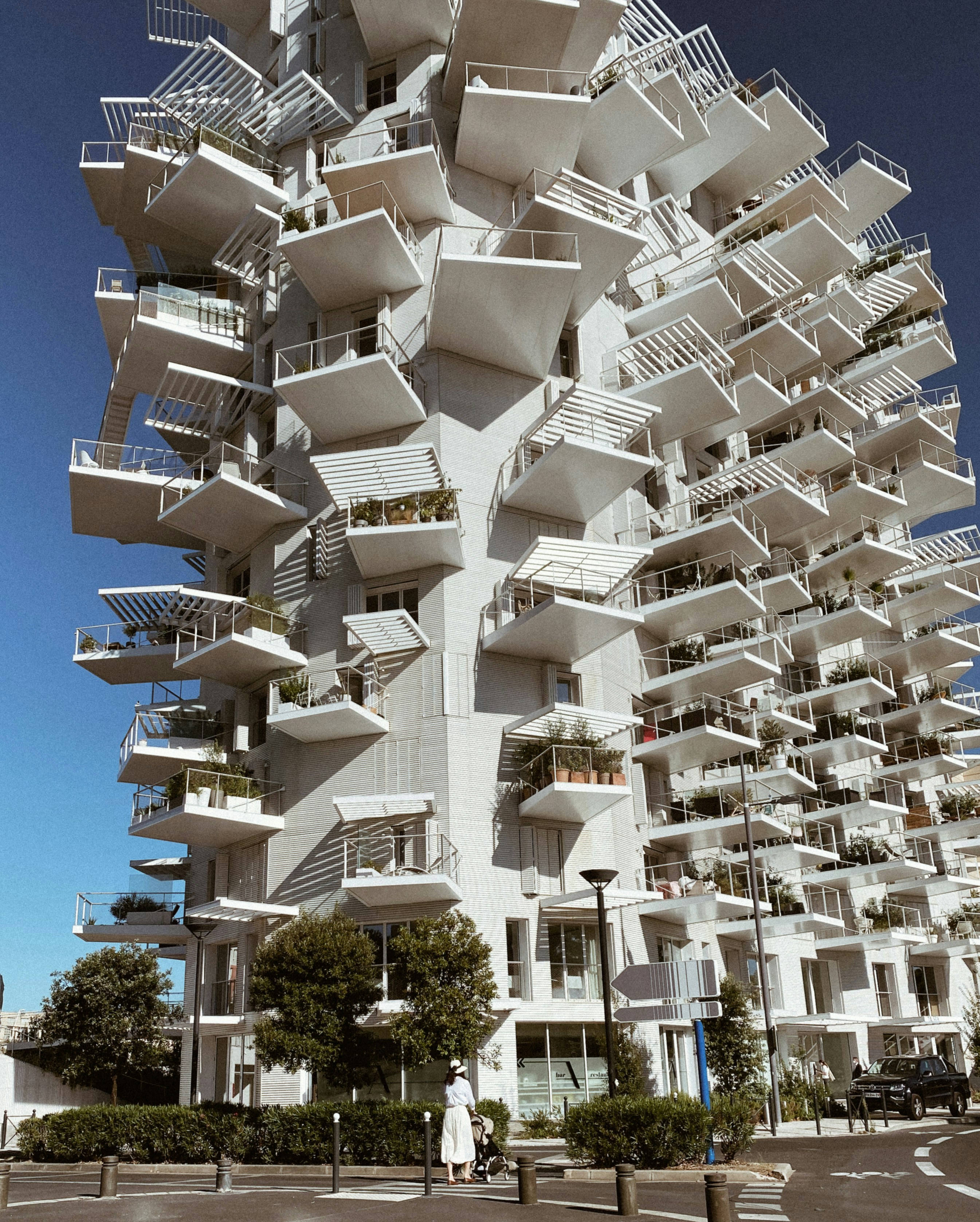 white concrete building near green trees during daytime