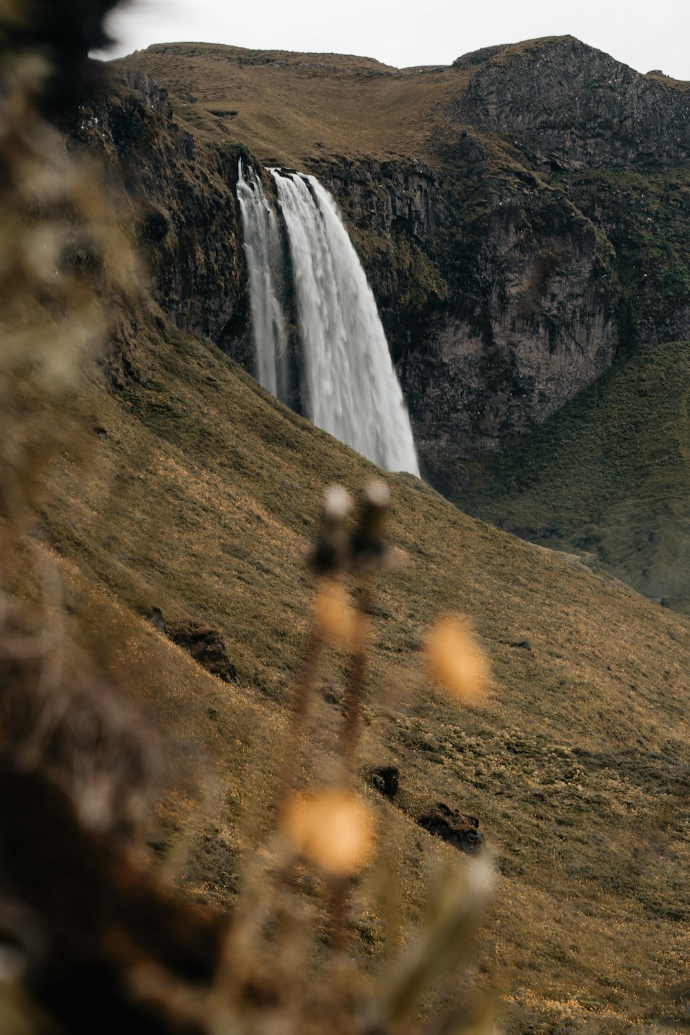 brown and green mountain with waterfalls during daytime