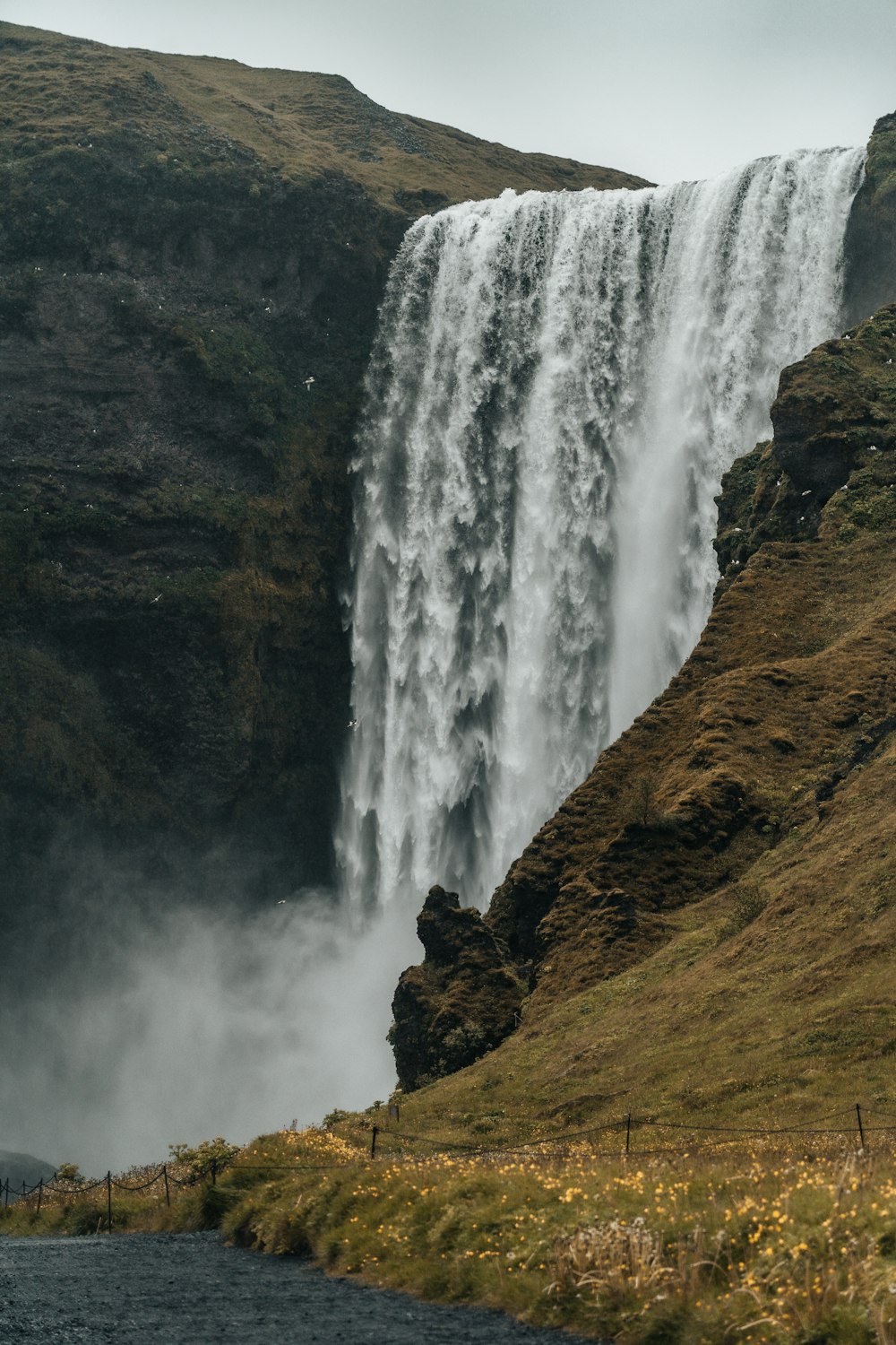 waterfalls on brown rocky mountain during daytime