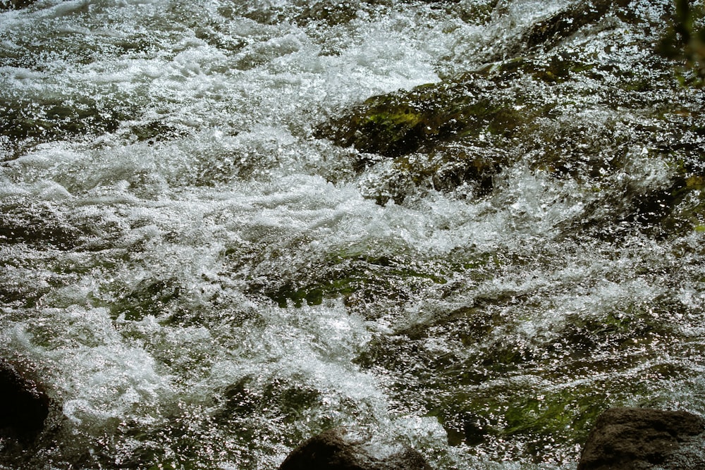 water waves hitting rocks during daytime