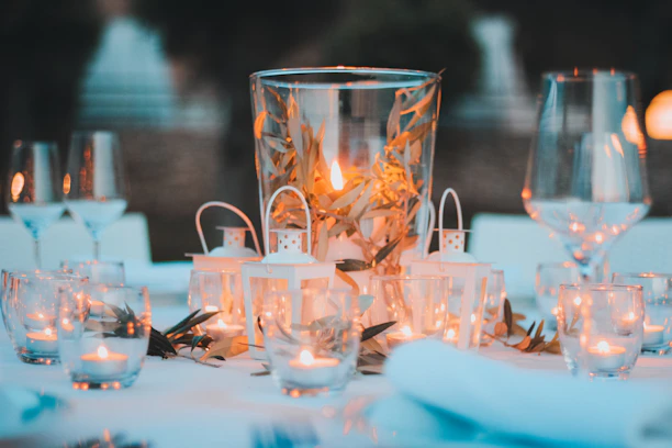 A close-up of a beautifully set table with lavender and olive branch accents under golden light.
