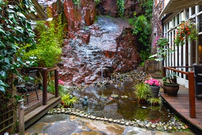 A peaceful outdoor garden space outside the spa, with flowing water and lush greenery.