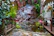 A serene lakefront garden featuring custom landscaping and a cozy seating area.