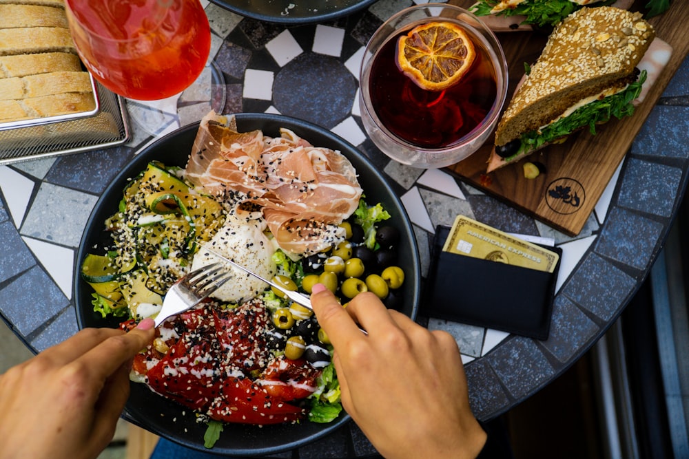 person holding stainless steel fork and knife