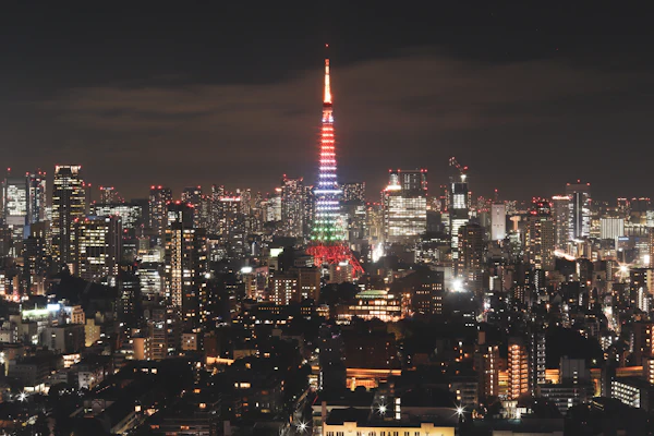 Tokyo Tower illuminated above the city skyline at night.