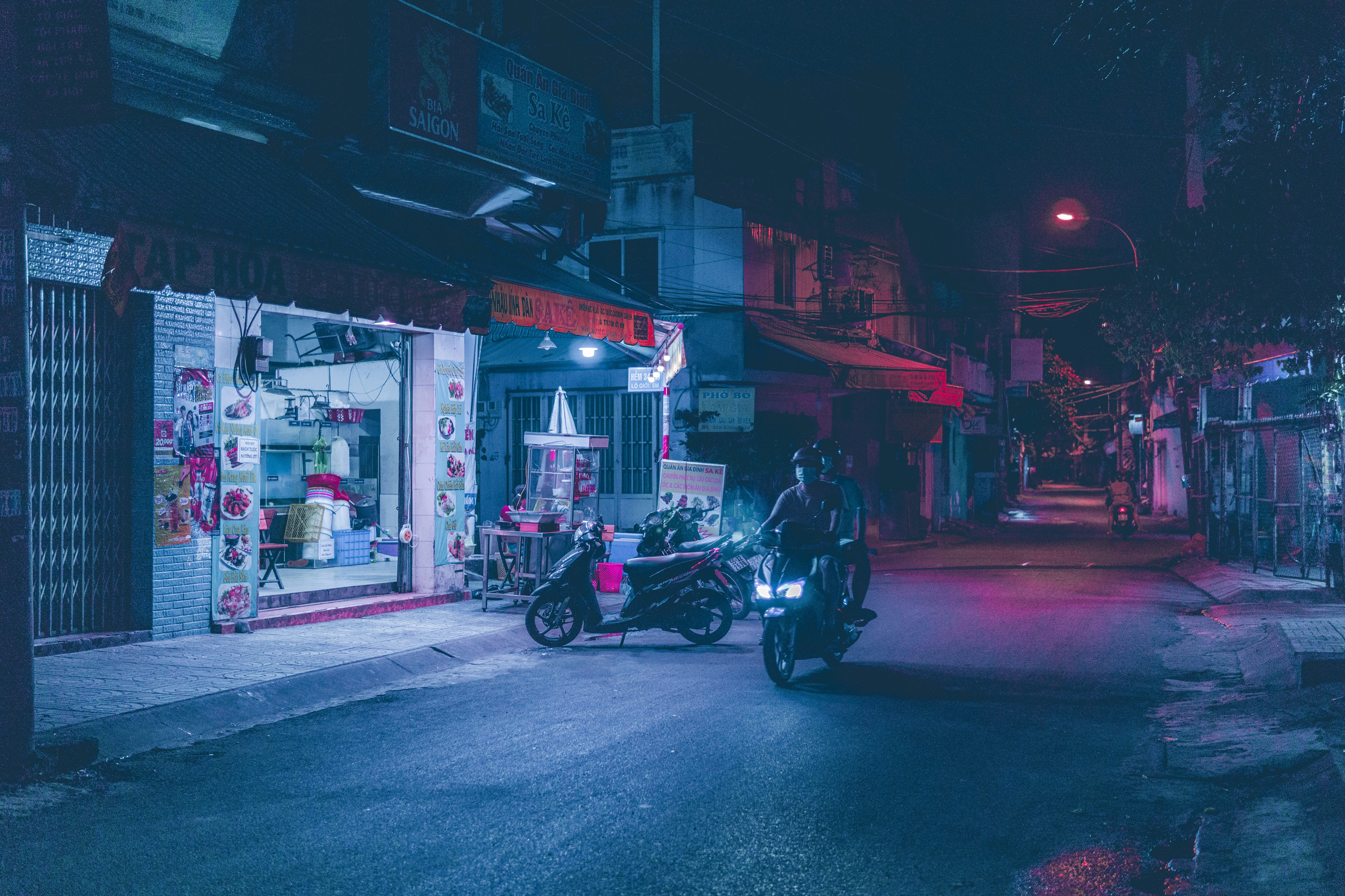 black motorcycle parked on street during night time