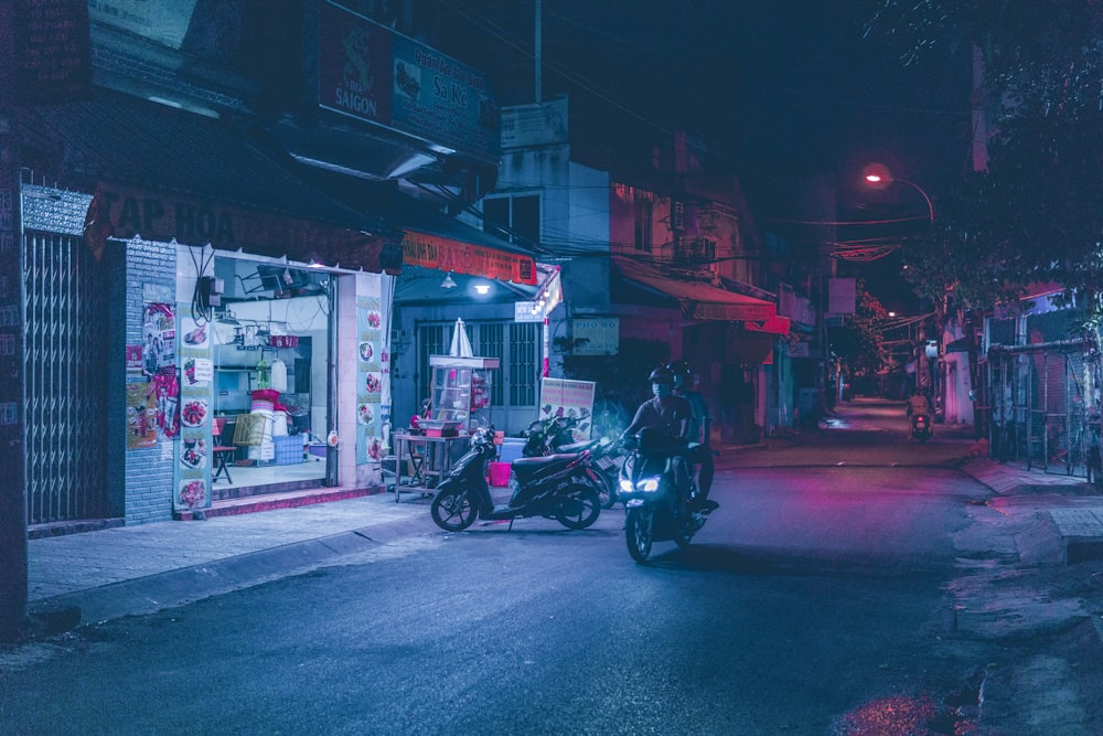 black motorcycle parked on street during night time