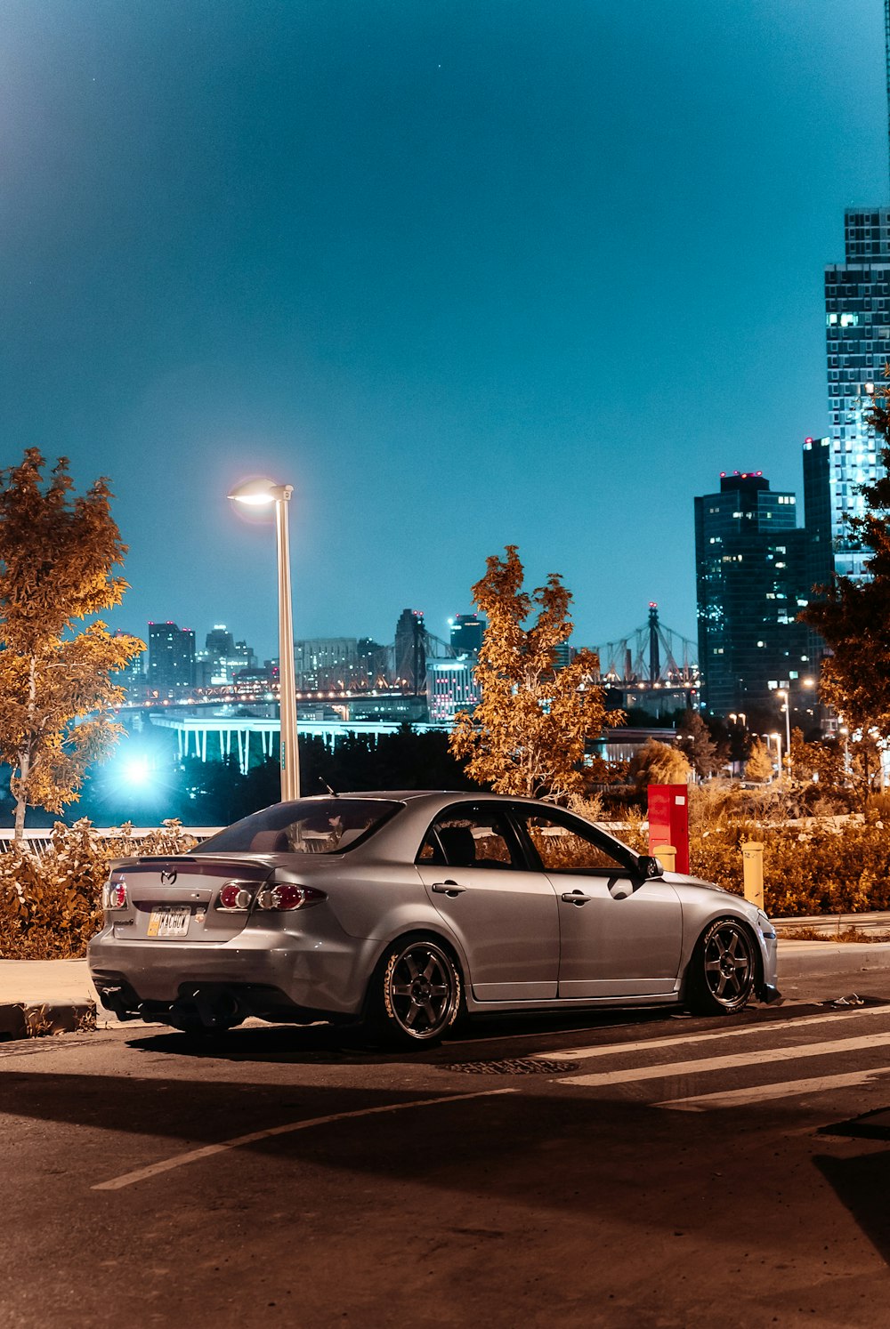 silver sedan on road during night time