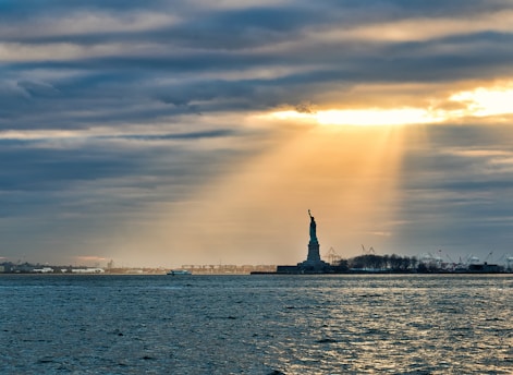 silhouette of statue of liberty during sunset