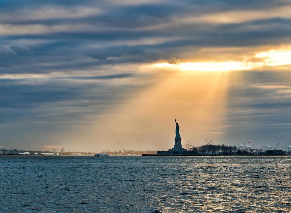 silhouette of statue of liberty during sunset