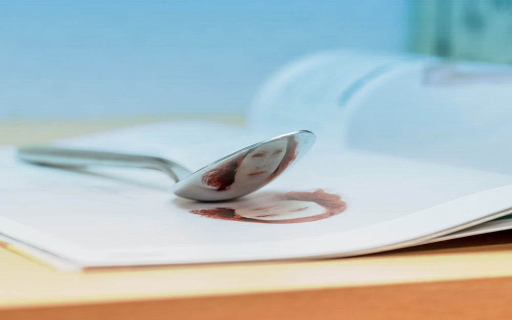 stainless steel spoon on white ceramic plate