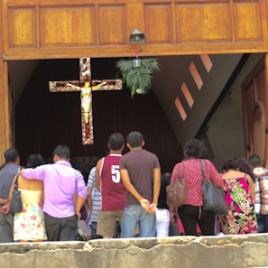 Old group photo of church leaders and pastors standing in front of the pulpit inside the sanctuary.